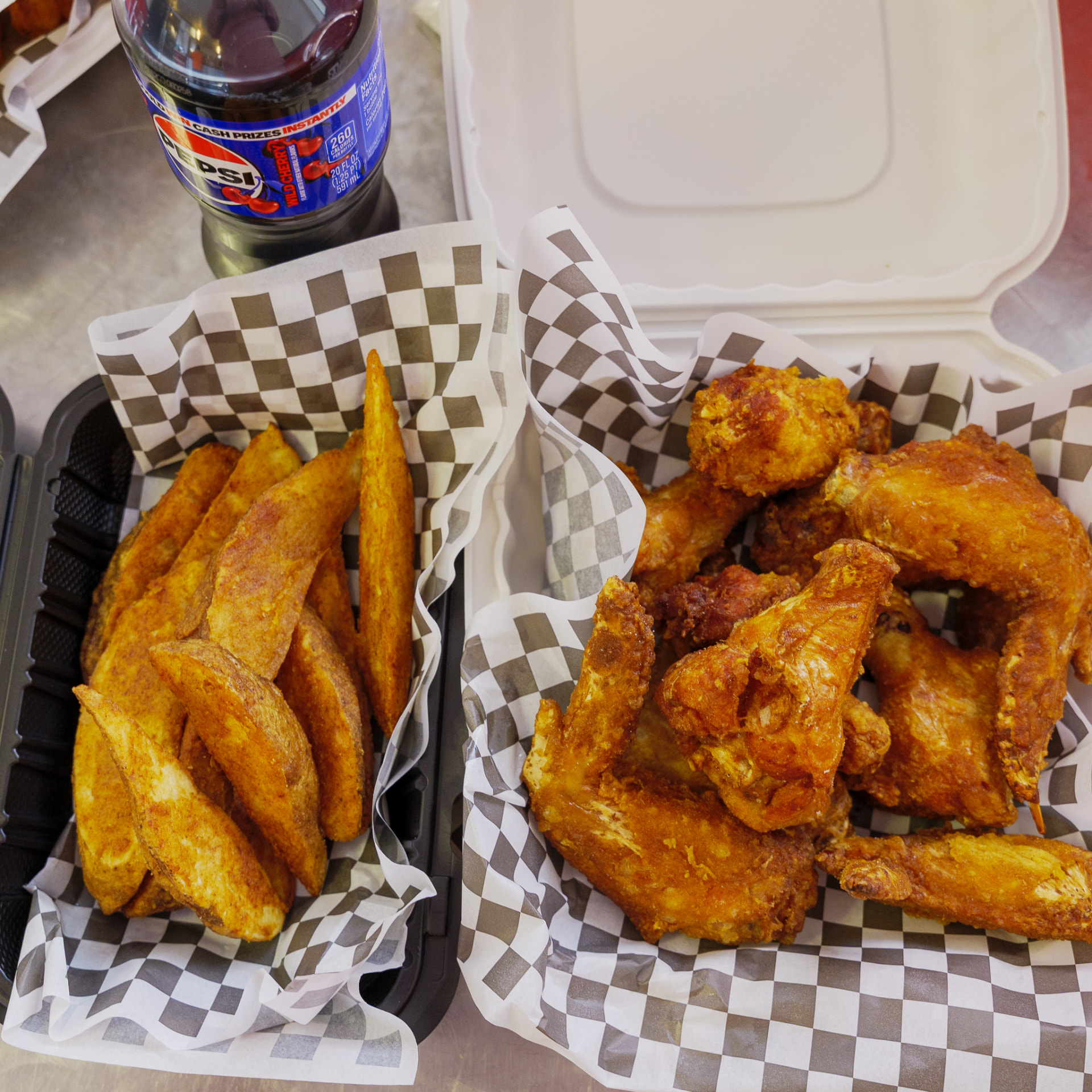 Fresh jumbo wings and seasoned potato wedges served at Sal's Birdland